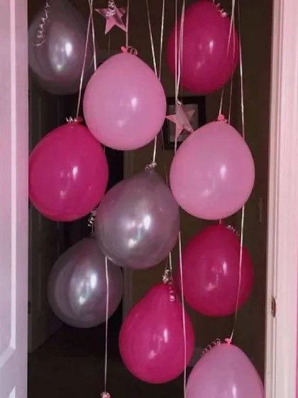 A simple yet charming doorway decoration. I used bunches of pink and silver balloons to create a welcoming entrance for a baby shower or welcome home party, setting a festive mood right from the start.