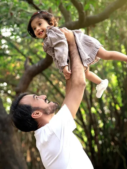 The pure delight of being a dad. This candid moment from an outdoor family session captures the playful, loving bond between a father and his little girl, surrounded by the beauty of nature.