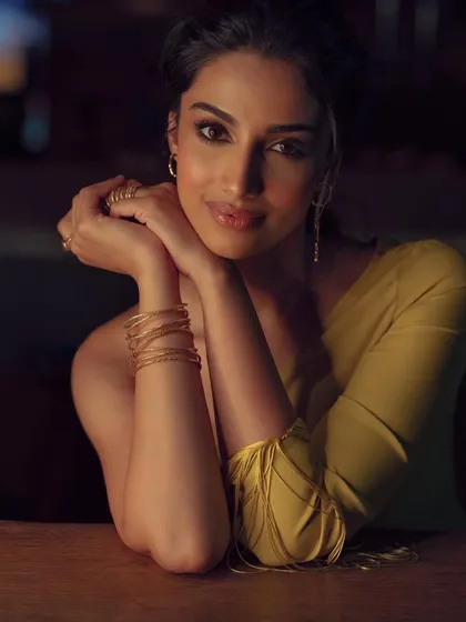 A duplicate of image 48, this close-up portrait showcases the soft, glamorous makeup and simple gold jewelry that perfectly complements the yellow evening dress.