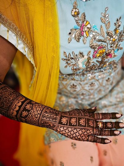 A side view of the lotus-filled bridal arm, showing how the design complements the bride's attire.
