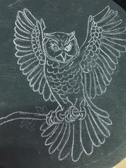 The foundation of the gold leaf owl, sketched in white on a black canvas. This step is crucial for defining the form and details, from the feathers to the intense gaze of the owl.