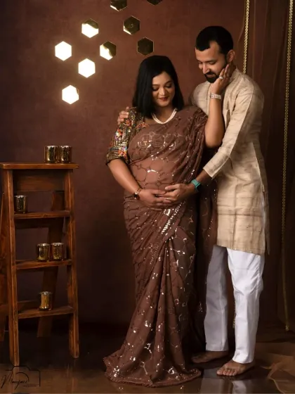 A tender moment between a couple in our "Shining Diva" setup. He gently caresses her face as they both hold the baby bump.