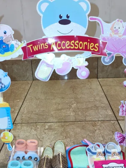 A special setup for twins, this 'Twins Accessories' cart is filled with double the fun, including pairs of shoes, socks, and bibs for both babies.