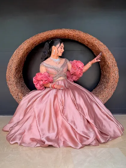A bride seated, showcasing her elegant high ponytail. This hairstyle is perfect for a long event as it keeps the hair securely off the neck and shoulders.