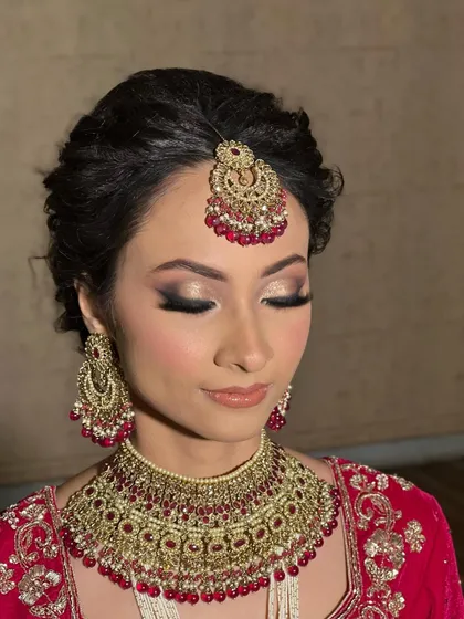 A close-up of the soft, blended smokey eye with a touch of gold glitter. It's a classic choice that enhances the eyes beautifully.