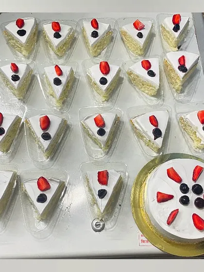 My eggless Milk Cake Pastries are an absolute crowd-pleaser. This shot shows a bulk order of my signature light sponge cake soaked in a sweet milk syrup, ready for an event. They are perfect for parties and corporate gatherings.