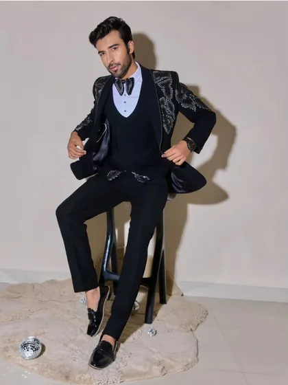 This shot showcases a complete look for a men's fashion shoot. The makeup is undetectable, simply enhancing the model's natural features and ensuring there's no distracting shine on the skin.