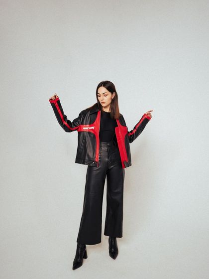 A dynamic, full-length pose that shows the jacket in motion. This adds a sense of energy and makes the product feel more wearable and less static.