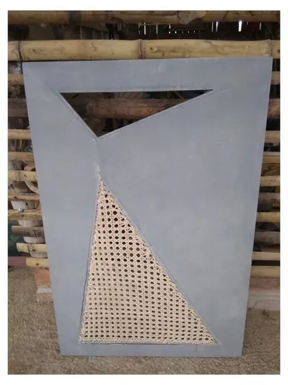 A finished panel combining a modern, geometric grey surface with a triangular, handwoven cane insert. This piece, designed for a cabinet shutter, blends contemporary design with traditional, natural materials for a fresh, retro feel.
