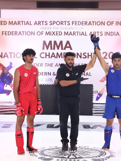 The referee raises our fighter's hand. A clear win at the MMA National Championship, a result of dedicated preparation and a solid game plan.