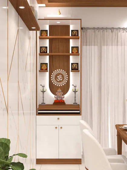 This pooja unit brings modern elegance to a sacred space. We used a combination of wood and white laminate, with soft, curved backlighting and a CNC-cut 'Om' motif. The design includes open shelves for idols and closed cabinets for storing pooja essentials.