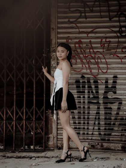 An edgy portrait using a graffiti-covered shutter as a textured, gritty background. This shows my ability to find and use unique urban locations for creative shoots.