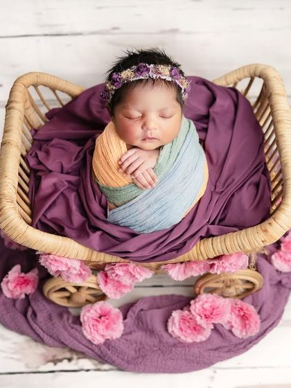 All of the beautiful colors for this little darling angel. Using a multi-colored wrap adds a touch of vibrancy while still keeping the setup classic and focused on the baby.