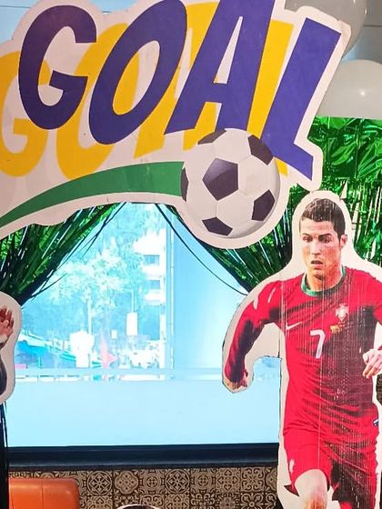 A football-themed party with life-sized cutouts of star players like Cristiano Ronaldo. This setup is perfect for any young sports fan and can be customized with their favorite teams or players.
