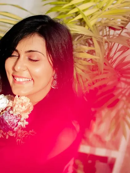 A joyful portrait with a creative red light leak effect, adding an artistic and vibrant touch to the image.