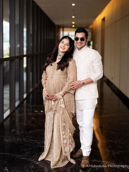 A classic couple portrait in a hallway, where the lighting highlights her radiant skin.