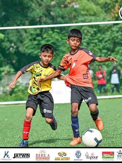 Two players challenge for the ball, showcasing the competitive spirit of the MDL U9 final.