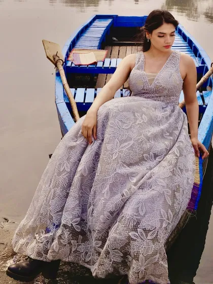 This elegant grey gown features a full skirt made from intricately embroidered floral lace. I designed it for a conceptual photoshoot, pairing the soft, romantic dress with rugged boots for a unique contrast. The V-neckline adds a modern touch to the classic silhouette.