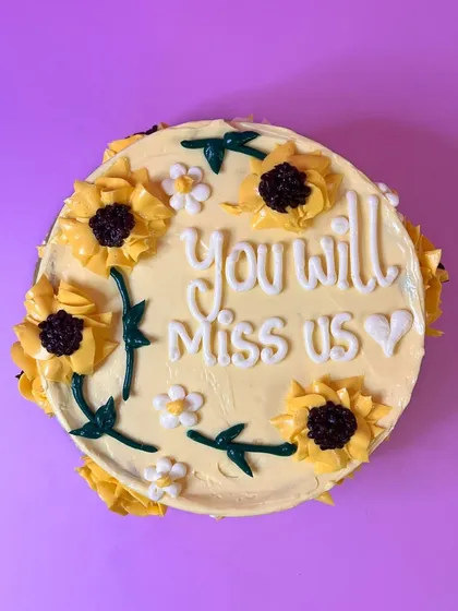 A sweet and passive-aggressive farewell cake. Decorated with hand-piped buttercream sunflowers, it’s a beautiful way to say they’ll definitely miss you.