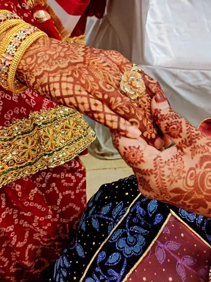 A beautiful shot of a couple holding hands, highlighting the bride's intricate henna stain.