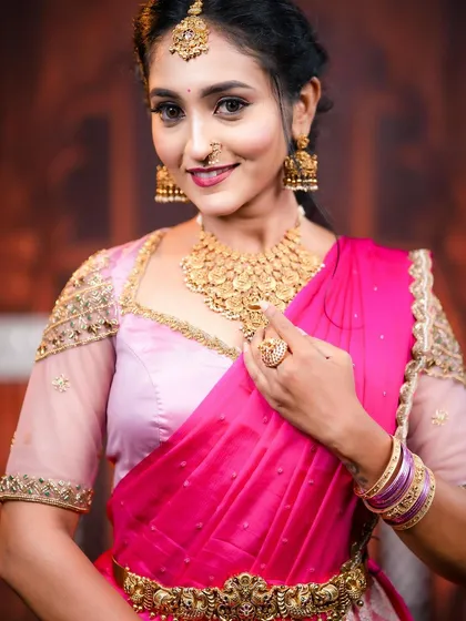 A close-up portrait showing the details of the maang tikka, nose ring, and the layered design of the choker.