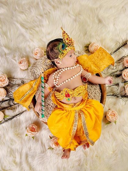 A slightly different angle of the peacock feather setup, showing the baby Krishna holding his flute. This highlights the creativity and detail in my themed shoots.