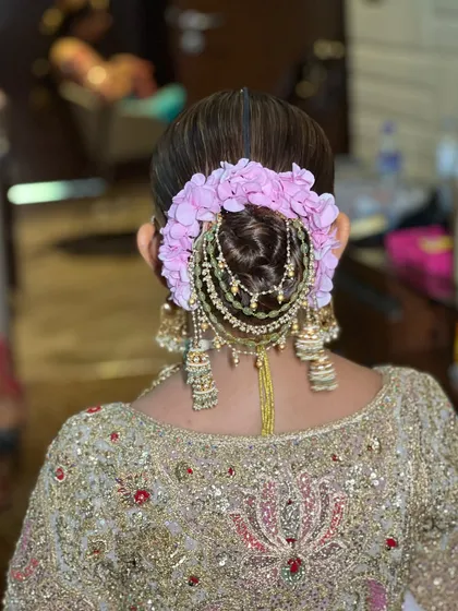 A close-up of a floral and jeweled bridal bun. The intricate design shows how different elements can be combined to create a one-of-a-kind hairstyle.