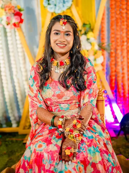 A smiling portrait of the client at her Haldi ceremony. The makeup is kept light and fresh to withstand the festivities.