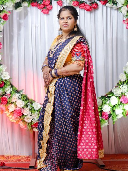 This client looks stunning in a royal blue Nauvari with a unique blouse featuring peacock embroidery on the sleeves.