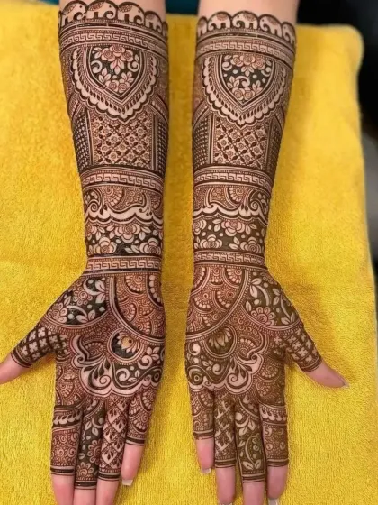 This full-arm bridal design is filled with classic Rajasthani elements, including checks, paisleys, and floral bands. It's a testament to timeless Indian artistry.