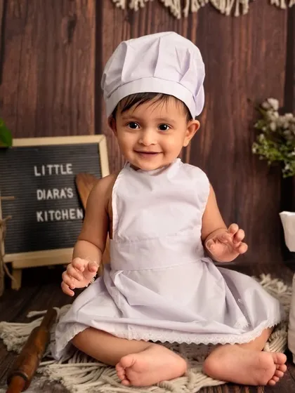 A proud smile from the head chef of her own little kitchen. This portrait perfectly captures her happy and sweet personality.