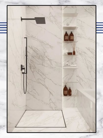 This minimalist walk-in shower design features floor-to-ceiling white marble and sleek black fixtures, creating a clean, spa-like experience.