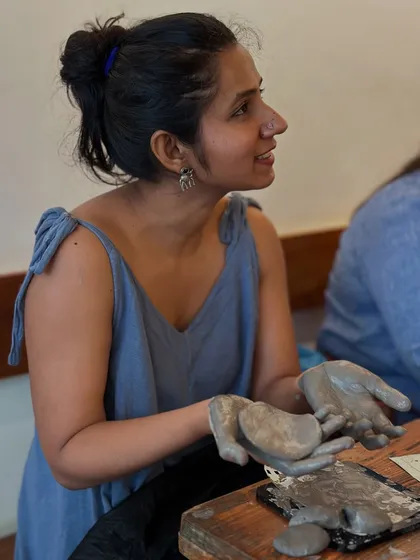 Holding a piece of freshly shaped clay. The tactile nature of pottery is what makes it so grounding and satisfying.