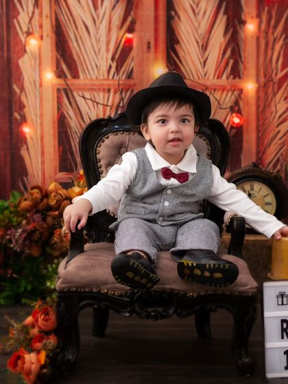 A little man looking confident in his vintage armchair. I use props to help children feel comfortable and let their personalities shine.