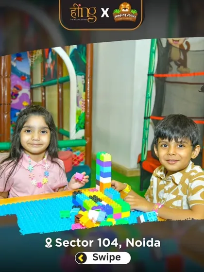 Two children building together with colorful blocks in the toddler section. This area encourages creativity and fine motor skill development.