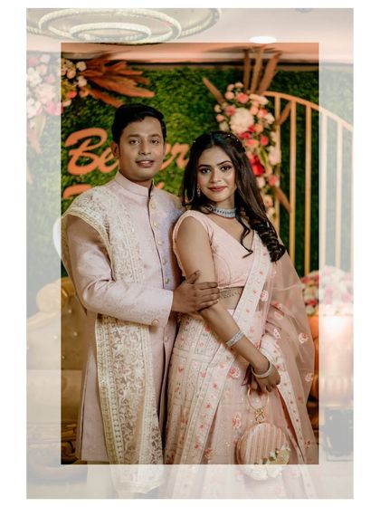 A classic portrait of the engaged couple against a vibrant, floral backdrop.