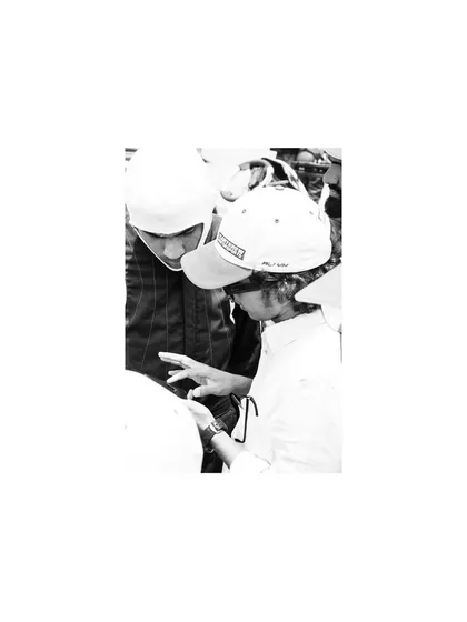 A black and white shot of a coach and driver, showing the mentorship aspect.