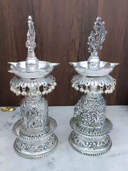 A different angle of the antique Hamsa designer vilakku, showing the detailed carving on the base and the elegant form of the sacred swan.