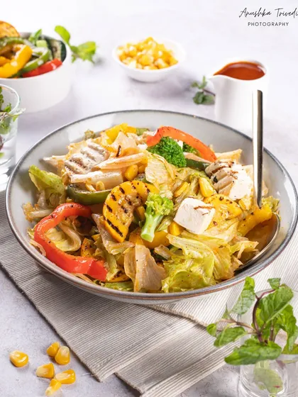 The finished salad, looking crisp and delicious. The bright, high-key lighting emphasizes the freshness of the ingredients, perfect for a health food brand or cafe.
