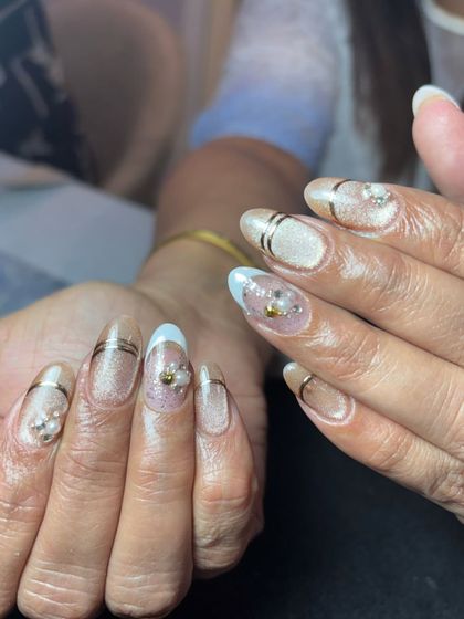 An elegant set with a shimmery cat-eye base, gold lines, and delicate pearl and crystal accents.