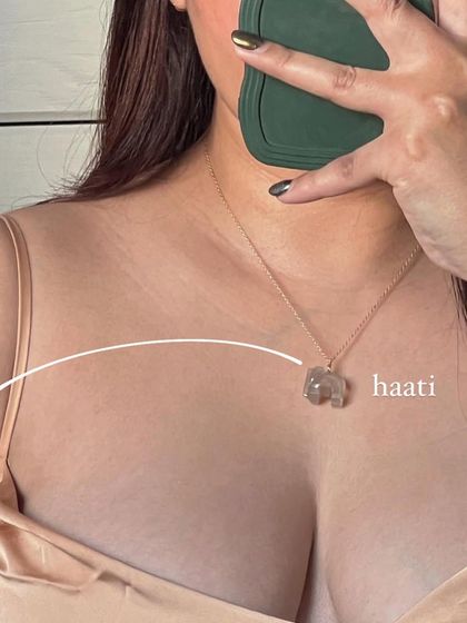 A lifestyle shot of the Grey Moonstone 'haati' pendant. This stone soothes emotional instability and stress.