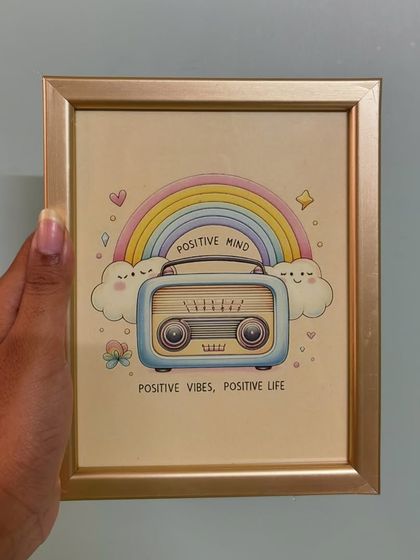A little reminder to stay positive. This cute frame features a vintage radio under a rainbow with the words "Positive Mind, Positive Vibes, Positive Life," perfect for a desk or shelf.