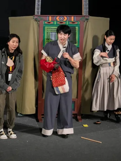 The performers of 'Hong Dongji & Isimi' explain their craft to the audience after the show, sharing insights into Korean traditional puppetry.