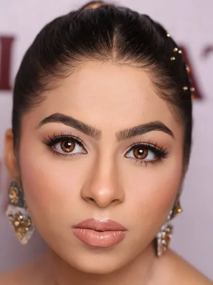A direct, powerful headshot from a masterclass. The focus is on the piercing eyes, enhanced by natural-toned makeup that defines and sculpts without overpowering.