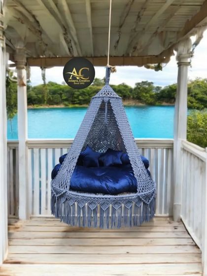 Imagine enjoying a lakeside view from this cozy grey macrame swing. We designed this for a penthouse, showing how our swings can transform any balcony into a peaceful retreat.