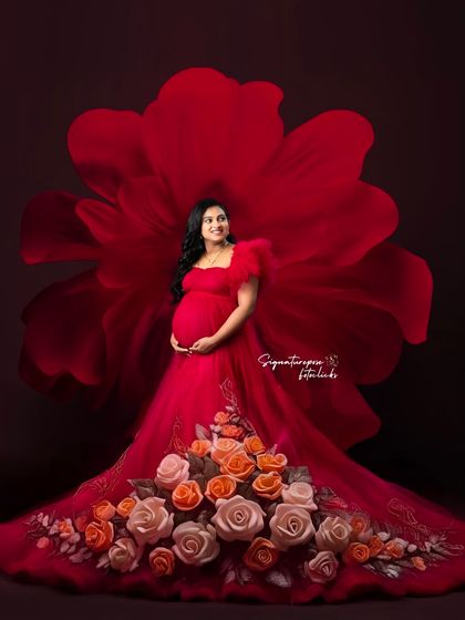 This creative portrait features a gown adorned with a cascade of roses, set against a giant floral silhouette.