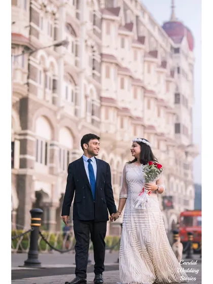 A classic, elegant walk hand-in-hand, with Mumbai's iconic Taj Mahal Palace Hotel providing a majestic backdrop. This style of pre-wedding photography focuses on creating timeless, sophisticated portraits.