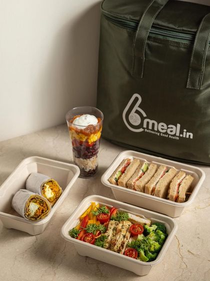 A full day's worth of meals, ready to go. This shows a typical delivery, including a sandwich, a wrap, a salad, and a parfait. We make healthy eating convenient from morning to night.