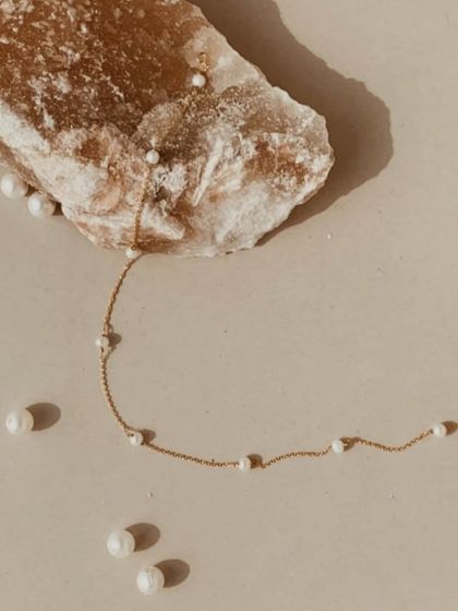 My freshwater pearl choker, laid out with loose pearls. This piece is handmade to help soothe the mind and calm anger.