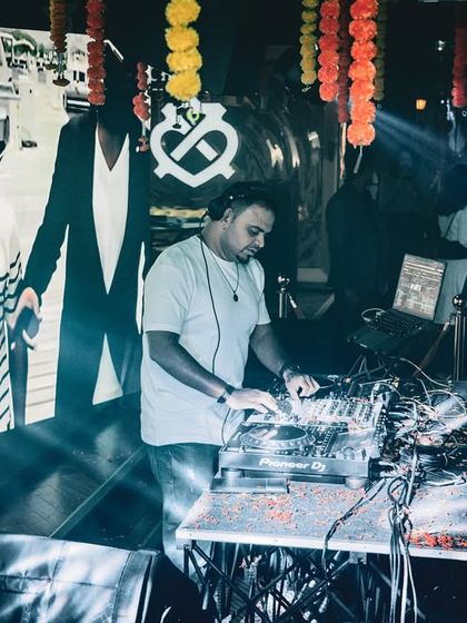 Mixing tracks with the VJ screen showing visuals in the background. This shot captures both the audio and visual elements of my performance.